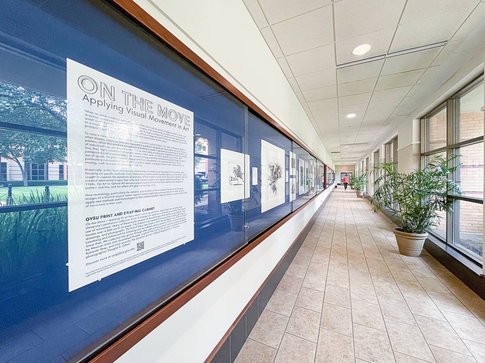 Photograph of an interior hallway with a wall gallery.